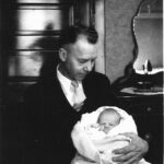 Otto F. Linn holds his eleven-day old daughter, Sheila.